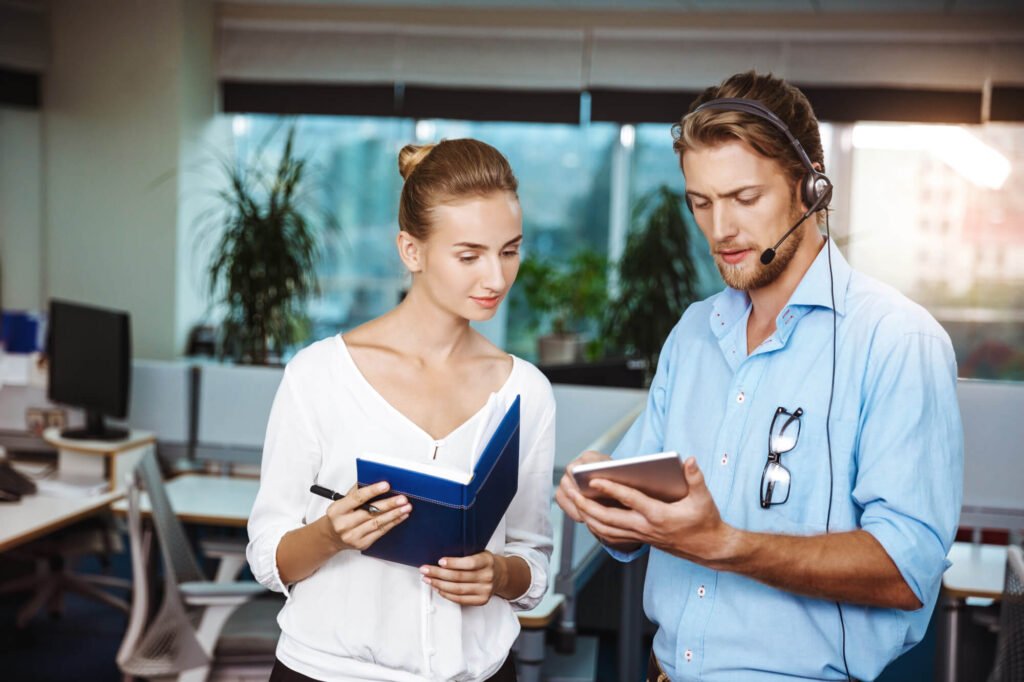 A customer service team discussing strategies in a modern office setting, highlighting the advantages of outsourcing customer service